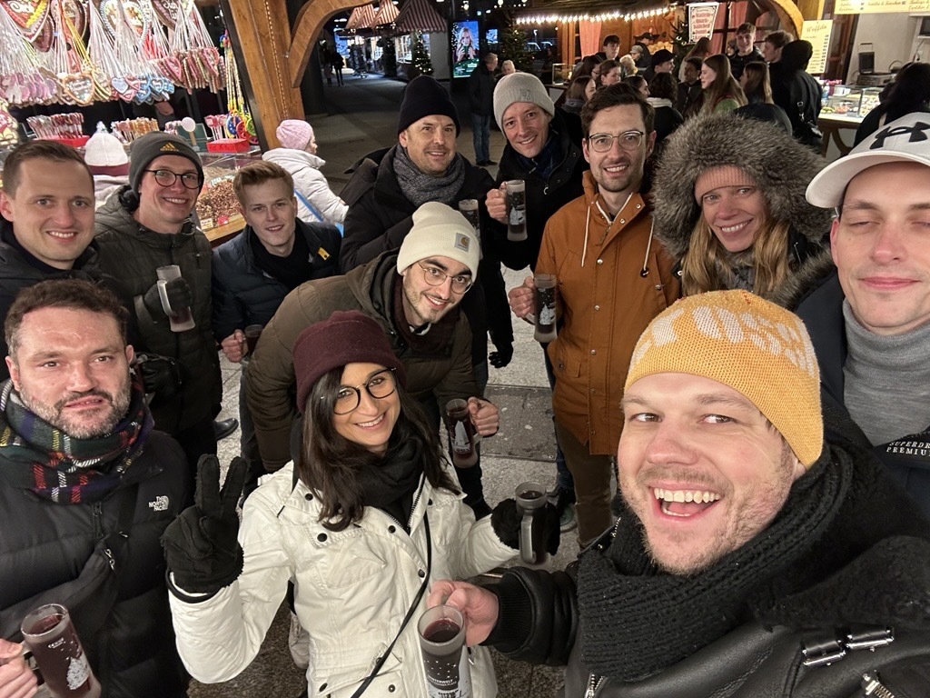 Team gathering at a festive Christmas market.