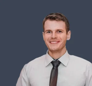 Lukasz, senior QA engineer in a professional picture, smiling.